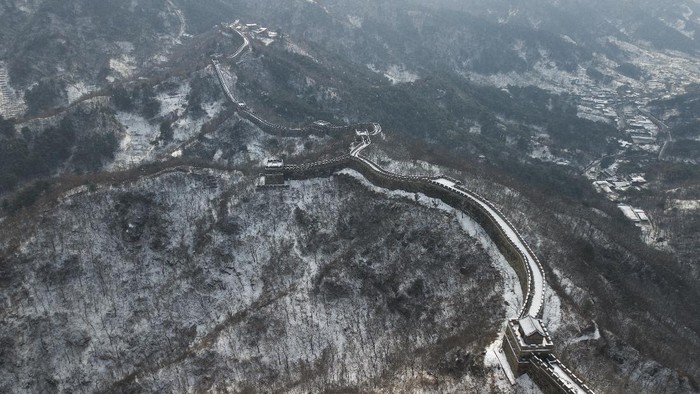 BEIJING, CHINA - FEBRUARY 23:  A family visits the Mutianyu Great Wall covered in snow on February 23, 2021 in Beijing, China. Affected by the new coronavirus (COVID-19), the number of visitors to Mutianyu Great Wall in 2020 dropped by about 60%.  (Photo by Lintao Zhang/Getty Images)