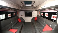 Bus juga dilengkapi ruang pertemuan memuat 8 orang lengkap dengan layar TV.