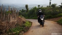 Hendri Kusmayadi yang bekerja sebagai Marketing Analisis dan Mikro (Mantri) Bank BRI menunggangi motornya menuju Pasir Jambu, Soreang, Bandung, untuk menemui petani yang menjadi nasabahnya.