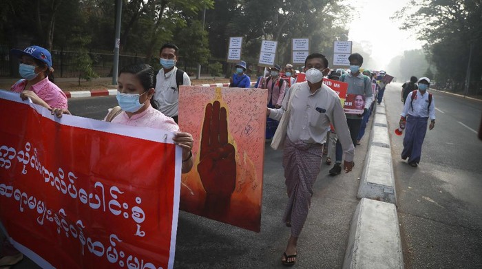 Hundreds of anti-coup protesters march in Yangon, Myanmar, Thursday, Feb. 25, 2021. Social media giant Facebook announced Thursday it was banning all accounts linked to Myanmars military as well as ads from military-controlled companies in the wake of the armys seizure of power on Feb. 1. (AP Photo)