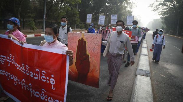 Hundreds of anti-coup protesters march in Yangon, Myanmar, Thursday, Feb. 25, 2021. Social media giant Facebook announced Thursday it was banning all accounts linked to Myanmar's military as well as ads from military-controlled companies in the wake of the army's seizure of power on Feb. 1. (AP Photo)