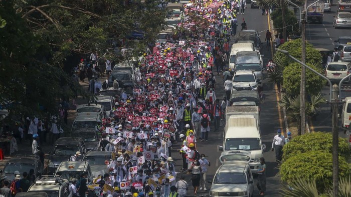 Hundreds of anti-coup protesters march in Yangon, Myanmar, Thursday, Feb. 25, 2021. Social media giant Facebook announced Thursday it was banning all accounts linked to Myanmars military as well as ads from military-controlled companies in the wake of the armys seizure of power on Feb. 1. (AP Photo)