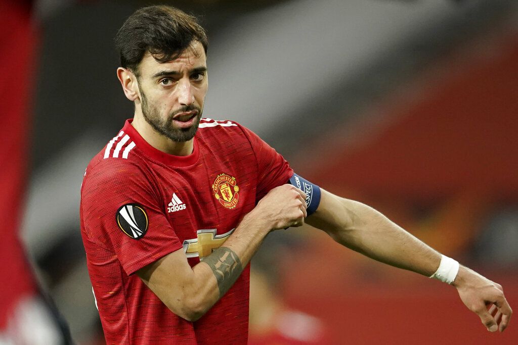Manchester United's Bruno Fernandes adjusts his captain armband during the Europa League round of 32, second leg, soccer match between Manchester United and Real Sociedad at Old Trafford in Manchester, England, Thursday, Feb. 25, 2021. (AP Photo/Dave Thompson)