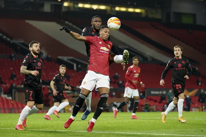 Real Sociedads Modibo Sagnan fights for the ball with Manchester Uniteds Anthony Martial, foreground, during the Europa League round of 32, second leg, soccer match between Manchester United and Real Sociedad at Old Trafford in Manchester, England, Thursday, Feb. 25, 2021. (AP Photo/Dave Thompson)