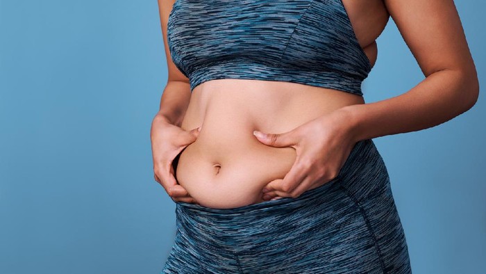 Ilustrasi Diet Cropped shot of an unrecognizable woman struggling with weight issues