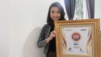 Marketing Communication PT Gajah Tunggal Tbk, Swenanda Yoanne Maria berfoto bersama plakat penghargaan di Jakarta, Senin (1/3/2021). Meskipun dalam kondisi pandemi, di era digitalisasi ini semua menjadi tantangan tersendiri bagi PT Gajah Tunggal Tbk untuk terus melakukan inovasi agar dapat terus membuktikan eksistensi kepada masyarakat meski lewat digital. Foto: dok. Gajah Tunggal