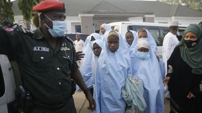 Some of the students who were abducted by gunmen from the Government Girls Secondary School, in Jangebe, last week wait for a medical checkup after their release meeting with the state Governor Bello Matawalle, in Gusau, northern Nigeria, Tuesday, March 2, 2021. Zamfara state governor Bello Matawalle announced that 279 girls who were abducted last week from a boarding school in the northwestern Zamfara state have been released Tuesday.(AP Photo/Sunday Alamba)