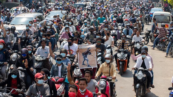 People attend the funeral procession for protester Kyal Sin, in Mandalay on March 4, 2021, a day after she was shot in the head while taking part in a demonstration against the military coup. (Photo by STR / AFP)