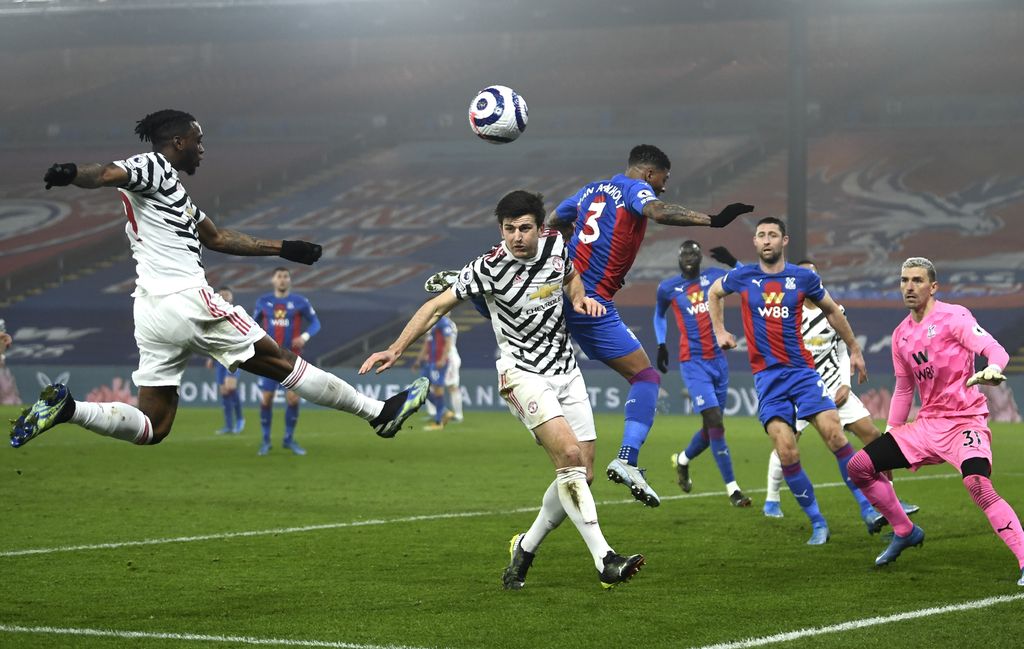 Crystal Palace vs Manchester United Manchester United's Aaron Wan-Bissaka, left, Harry Maguire and Crystal Palace's Patrick van Aanholt battle for the ball during the English Premier League soccer match between Crystal Palace and Manchester United at Selhurst Park stadium in London, England, Wednesday, March 3, 2021. (Mike Hewitt/Pool via AP)