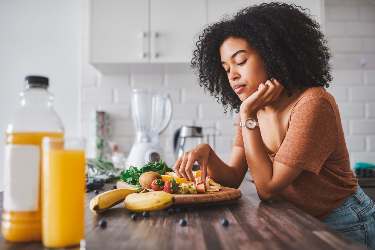 Shot of a young woman looking unhappy while making a healthy snack with fruit at home