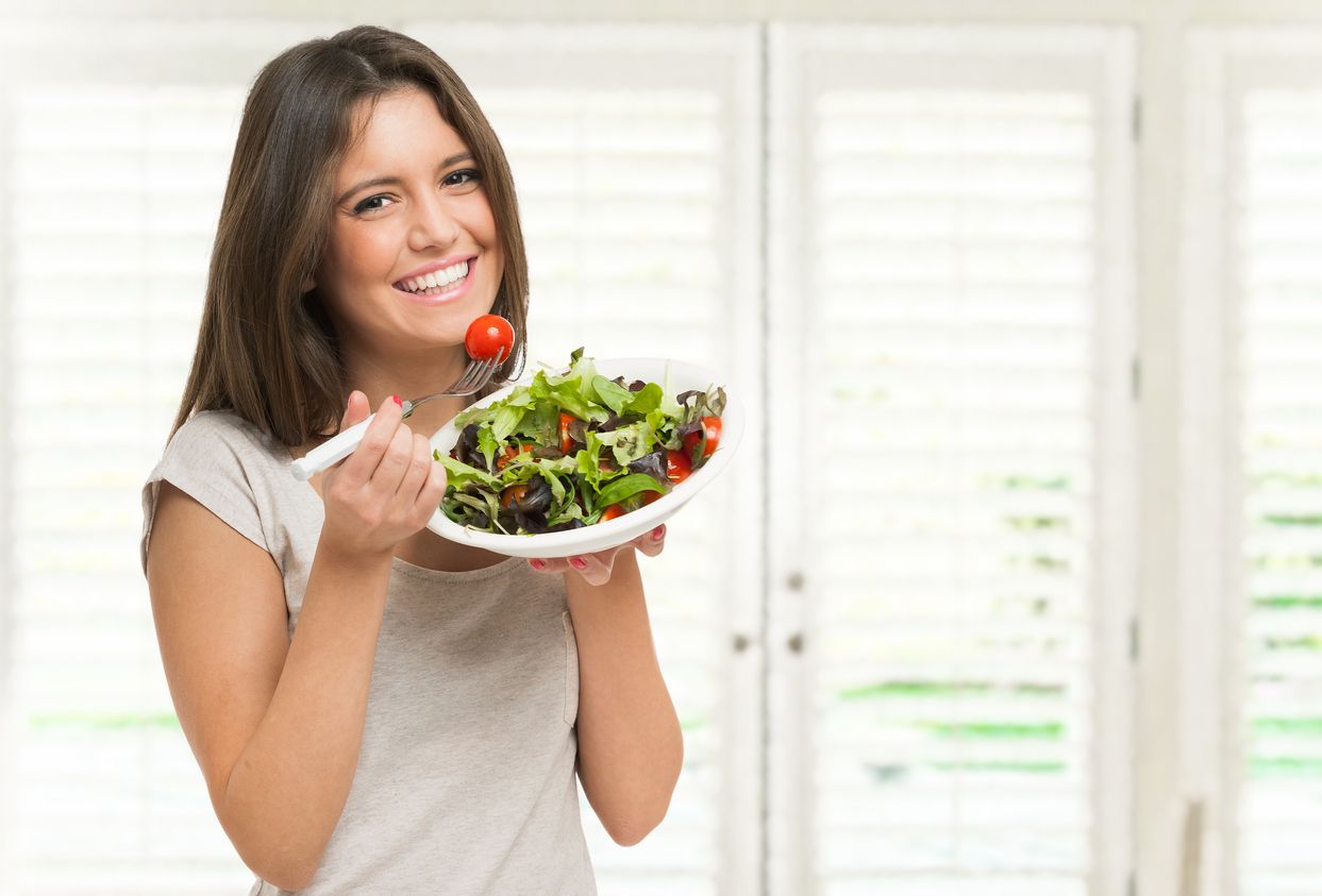 Young woman eating a healthy salad