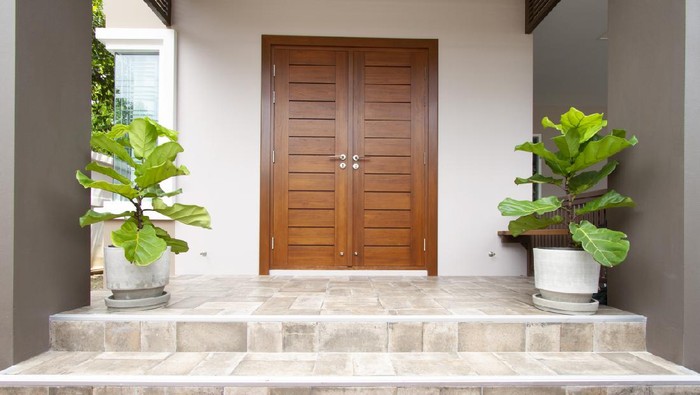 Main entrance of residential house with tiled floor and steps