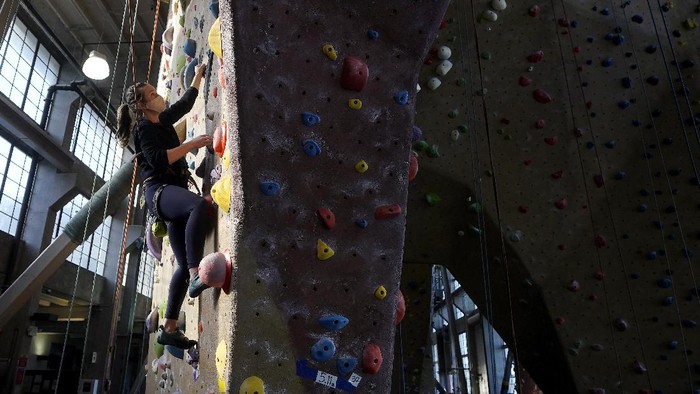 Audrey Grochowski, left, and Sam Masters wear protective face masks while working out at Planet Granite climbing gym during the coronavirus pandemic in San Francisco, Thursday, March 4, 2021. The gym opened today to allow ten percent capacity. (AP Photo/Jeff Chiu)