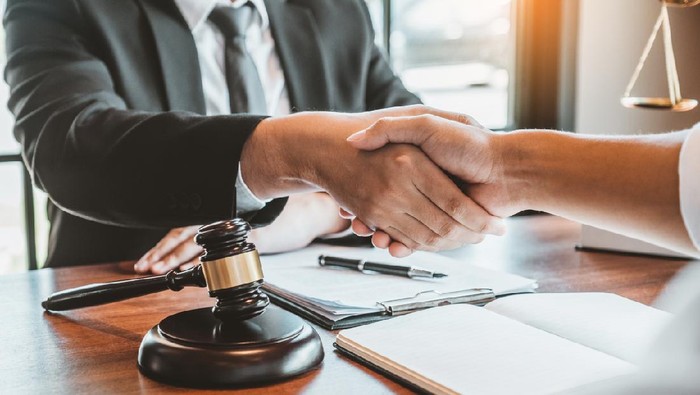 Businessman shaking hands to seal a deal Judges male lawyers Consultation legal services Consulting in regard to the various contracts to plan the case in court.