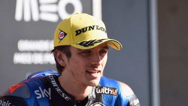 PORTIMAO, PORTUGAL - NOVEMBER 22:  Luca Marini of Italy and Sky Racing Team VR46 speaks with journalist ald celebrates the second place under the podium during the Moto2 race during the MotoGP of Portugal at Algarve Motor Park on November 22, 2020 in Portimao, Portugal. (Photo by Mirco Lazzari gp/Getty Images)