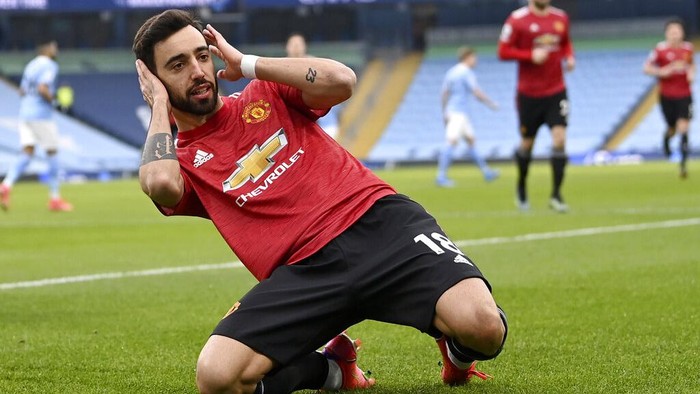 Manchester Uniteds Bruno Fernandes celebrates after scoring the opening goal during the English Premier League soccer match between Manchester City and Manchester United at the Etihad Stadium in Manchester, England, Sunday, March 7, 2021. (Laurence Griffiths/Pool via AP)