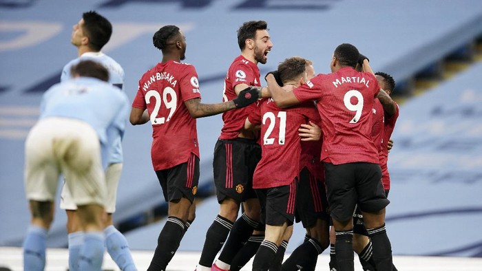Manchester United players celebrate after scoring their second goal during the English Premier League soccer match between Manchester City and Manchester United at the Etihad Stadium in Manchester, England, Sunday, March 7, 2021. (Dave Thompson/Pool via AP)