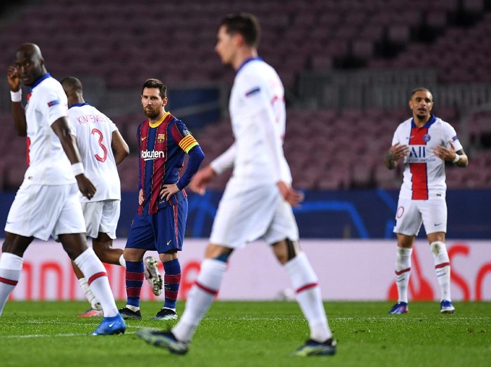 BARCELONA, SPAIN - FEBRUARY 16: Lionel Messi of FC Barcelona reacts after conceding their fourth goal during the UEFA Champions League Round of 16 match between FC Barcelona and Paris Saint-Germain at Camp Nou on February 16, 2021 in Barcelona, Spain. Sporting stadiums around Spain remain under strict restrictions due to the Coronavirus Pandemic as Government social distancing laws prohibit fans inside venues resulting in games being played behind closed doors. (Photo by David Ramos/Getty Images)