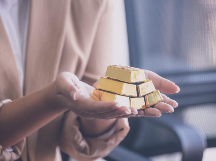 Woman holding gold bullion ,business and trading concept