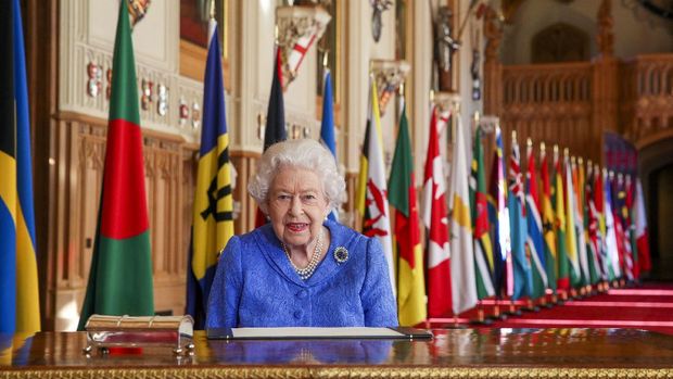 In this photo made available Sunday March 7, 2021, Britain's Queen Elizabeth II poses for a photo while signing her annual Commonwealth Day Message inside St George's Hall at Windsor Castle, England, Friday March 5, 2021. (Steve Parsons/Pool via AP)