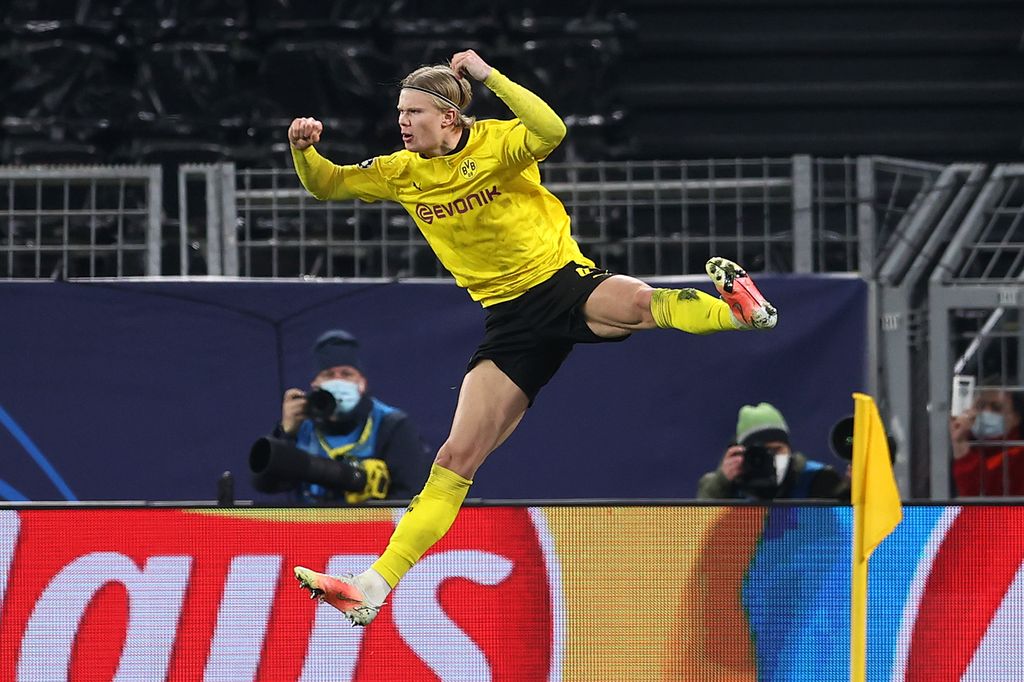 DORTMUND, GERMANY - MARCH 09: Erling Haaland of Borussia Dortmund celebrates after scoring their side's second goal from the penalty spot during the UEFA Champions League Round of 16 match between Borussia Dortmund and Sevilla FC at Signal Iduna Park on March 09, 2021 in Dortmund, Germany. Sporting stadiums around Germany remain under strict restrictions due to the Coronavirus Pandemic as Government social distancing laws prohibit fans inside venues resulting in games being played behind closed doors. (Photo by Lars Baron/Getty Images)