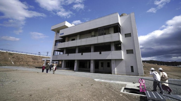 Menenang Satu Dekade, Ada Wisata Keliling Lokasi Tsunami Jepang Fumio Ito, head of public relations at Minami Sanriku Hotel Kanyo, tells his experience of 2011 tsunami disaster in the area to participants inside a bus during the