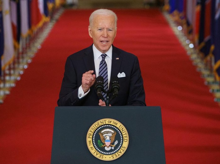US President Joe Biden gestures as he speaks on the anniversary of the start of the Covid-19 pandemic, in the East Room of the White House in Washington, DC on March 11, 2021. (Photo by MANDEL NGAN / AFP)