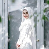 Di hari pernikahannya, Jihan tampak cantik mengenakan gaun putih panjang dan hijab berwarna senada. Penampilannya itu semakin terlihat menawan dengan ulasan makeup natural di wajahnya. Foto: Instagram/@thepotomoto