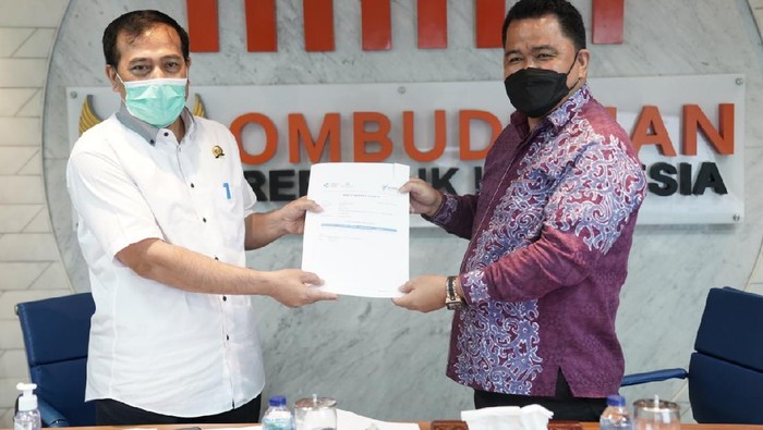 Ketua Ombudsman RI Mokhammad Najih menerima Kartu Vaksinasi Covid-19 dari Plt. Dirjen Pencegahan dan Pengendalian Penyakit (P2P) Kementerian Kesehatan RI Maxi Rein Rondonuwu setelah mendapat vaksinasi di Kantor Ombudsman, Senin (15/3/2021).