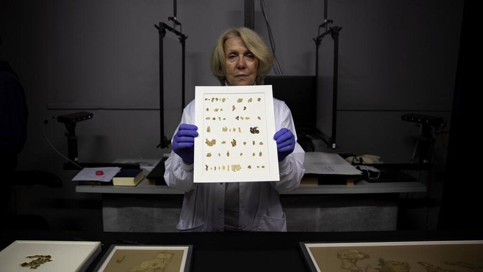 Israel Antiquities Authority conservator Tanya Bitler shows newly discovered Dead Sea Scroll fragments at the Dead Sea scrolls conservation lab in Jerusalem, Tuesday, March 16, 2021. Israeli archaeologists on Tuesday announced the discovery of dozens of new Dead Sea Scroll fragments bearing a biblical text found in a desert cave and believed hidden during a Jewish revolt against Rome nearly 1,900 years ago. (AP Photo/Sebastian Scheiner)