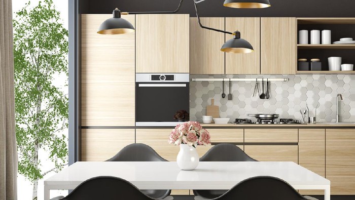 Trendy Scandinavian open concept kitchen and dining room with lots of natural light.
Functional, modern and bright one wall kitchen with gray and white wooden cabinets, 
open light wood shelves and light gray honeycomb ceramic back-splash tiles. 
Wooden white dining table and black wooden retro chairs are placed next to a big panoramic window. 
Vintage, big, black metal lighting fixture, wall clock and black and white picture are decorative elements.
Light hardwood flooring.