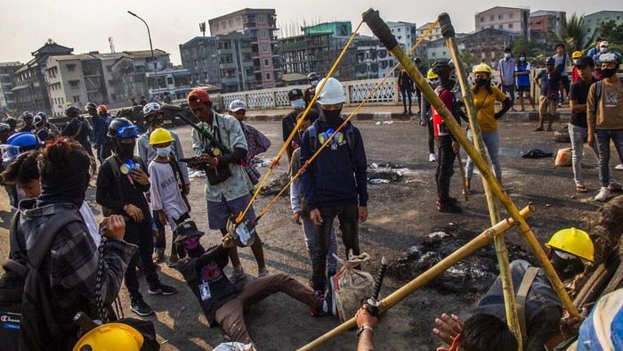 Anti-coup protesters test an improvised weapon they have made to fight with armed Myanmar security forces in Yangon, Myanmar Wednesday, March 17, 2021. (AP Photo)
