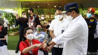 Budi menyempatkan diri untuk berfoto bersama para peserta vaksinasi. Dia terus mengacungkan jempol dan mengajak peserta melakukan tos dengan kepalan tangan.