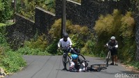 Pesepeda terjatuh saat menundukkan kemiringan jalan di kawasan Megamendung. Kemiringan jalan mengikuti kontur tanah yang naik turun terutama saat melintasi sungai.