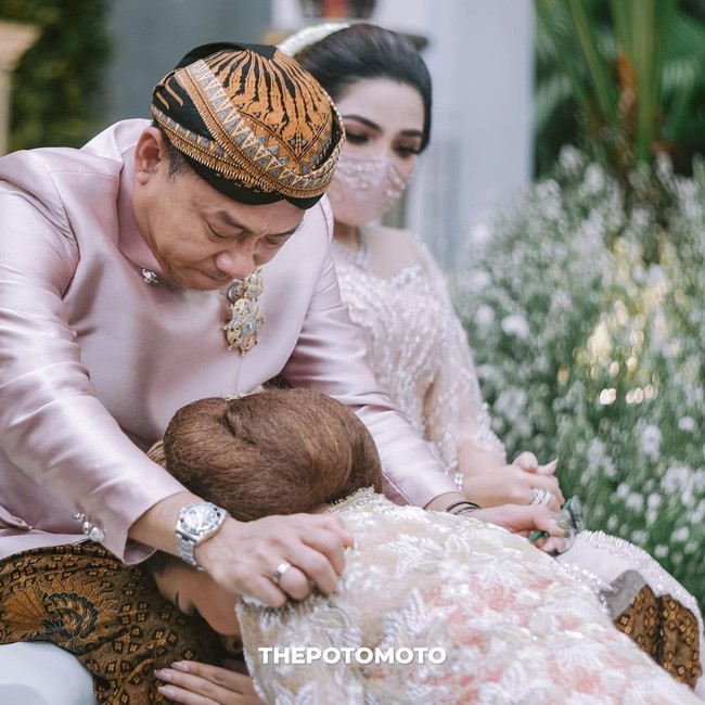 Terdapat pula sesi sungkeman di acara yang disiarkan secara langsung oleh sebuah stasiun TV swasta ini. Tampak Anang dan Ashanty sempat terharu ketika Aurel bersimpuh di kaki mereka. (Foto: Dok. The Potomoto)