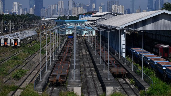 Pekerja membersihkan rumput di Depo Cipinang, Jakarta Timur, Minggu (21/3/2021). Kementerian Perhubungan menyatakan Depo Cipinang merupakan depo kereta api terbesar di Indonesia yang memiliki 28 jalur kereta, mampu merawat 144 lokomotif dan 120 gerbong kereta per hari serta dibangun di atas lahan seluas sembilan hektare dengan biaya hampir Rp500 miliar. ANTARA FOTO/Sigid Kurniawan/wsj.