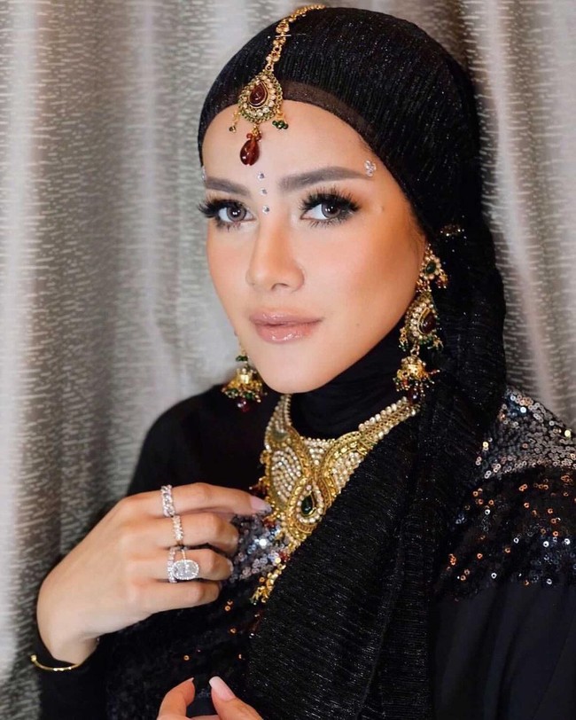 Perhiasan berwaran emas seperti kalung, anting, cincin dan headpiece membuat penampilannya makin glamor. Foto: Instagram/@ollaramlanaufar