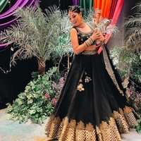 Nindy Ayunda pun tak kalah tampil glmor. Ia mengenakan atasan crop top dan rok bervolume nuansa hitam-emas. Tak lupa aksesori kepala, bangles dan selendang sebagai pelengkap penampilan. Foto: Instagram/@nindyparasadyharsono