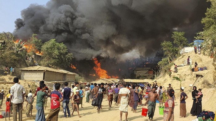 Smoke rises following a fire at the Rohingya refugee camp in Balukhali, southern Bangladesh, Monday, March 22, 2021. The fire destroyed hundreds of shelters and left thousands homeless, officials and witnesses said. (AP Photo/ Shafiqur Rahman)