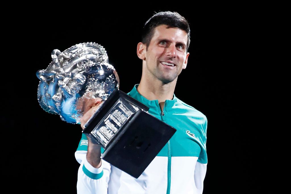 MELBOURNE, AUSTRALIA - FEBRUARY 21: Novak Djokovic of Serbia kisses the Norman Brookes Challenge Cup as he celebrates victory in his Men's Singles Final match against Daniil Medvedev of Russia during day 14 of the 2021 Australian Open at Melbourne Park on February 21, 2021 in Melbourne, Australia. (Photo by Daniel Pockett/Getty Images)