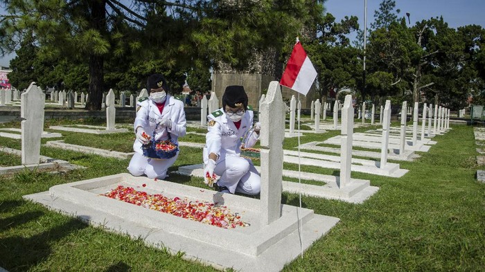 Dua anggota Paskibraka Kota Bandung melakukan tabur bunga saat ziarah Peringatan Ke-75 Peristiwa Bandung Lautan Api di Taman Makam Pahlawan Cikutra, Bandung, Jawa Barat, Selasa (23/3/2021).  Pemerintah Kota Bandung menggelar ziarah dengan protokol kesehatan untuk tetap mengenang dan menjaga jasa para tentara dan penduduk sipil saat peristiwa Bandung Lautan Api pada tahun 1946 dalam membela Indonesia dari penjajah Sekutu dan NICA. ANTARA FOTO/Novrian Arbi/aww.