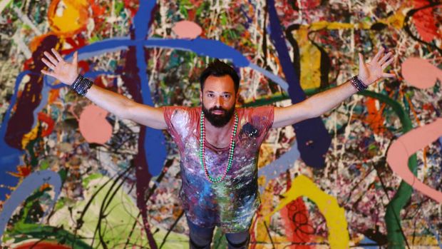 DUBAI, UNITED ARAB EMIRATES - SEPTEMBER 09: Artist Sacha Jafri works on his canvas 