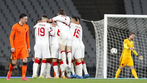 Turkey's Hakan Calhanoglu celebrates with his teammates after scoring his side's third goal during the World Cup 2022 group G qualifying soccer match between Turkey and Netherlands at the Ataturk Olimpiyat Stadium in Istanbul, Turkey, Wednesday, March 24, 2021. (Murad Sezer/Pool Photo via AP)