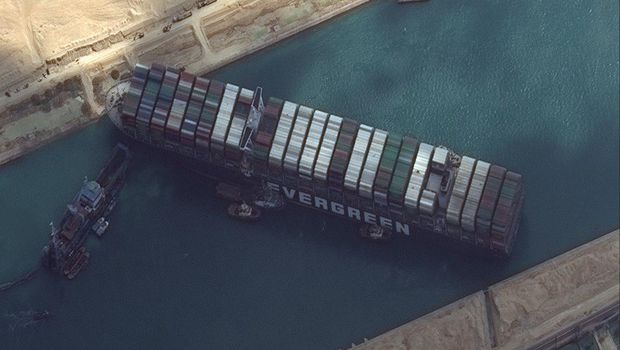 This satellite image from Maxar Technologies shows the cargo ship MV Ever Given stuck in the Suez Canal near Suez, Egypt, Friday, March 26, 2021. A maritime traffic jam grew to more than 200 vessels Friday outside the Suez Canal and some vessels began changing course as dredgers worked frantically to free a giant container ship that is stuck sideways in the waterway and disrupting global shipping. (©Maxar Technologies via AP)