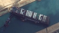 Setelah berbagai upaya dilakukan, kapal raksasa itu masih belum bisa dibebaskan dan citra satelit menunjukkan posisinya masih melintang di seluruh lebar kanal. Maxar Technologies via AP.