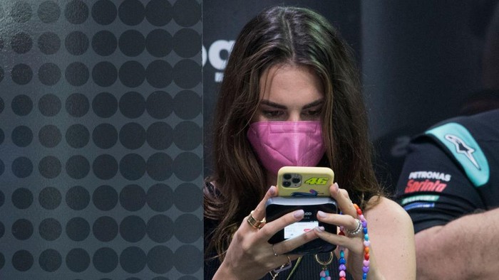 DOHA, QATAR - MARCH 26: Francesca Sofia Novello of Italy (girlfriend of Valentino Rossi of Italy and Petronas Yamaha SRT ) on her mobile phone in box during the MotoGP of Qatar - Free Practice at Losail Circuit on March 26, 2021 in Doha, Qatar. (Photo by Mirco Lazzari gp/Getty Images)