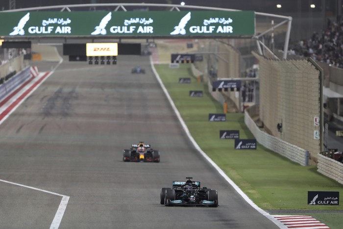 Mercedes driver Lewis Hamilton of Britain steers his car followed by Red Bull driver Max Verstappen of the Netherlands during the Bahrain Formula One Grand Prix at the Bahrain International Circuit in Sakhir, Bahrain, Sunday, March 28, 2021. (AP Photo/Kamran Jebreili)
