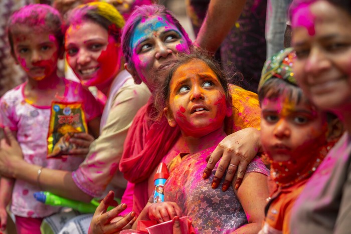 Indians smeared in color participate in Holi festival celebrations in Gauhati, India, Monday, March 29, 2021. Hindus threw colored powder and sprayed water in massive Holi celebrations Monday despite many Indian states restricting gatherings to try to contain a coronavirus resurgence rippling across the country. (AP Photo/Anupam Nath)
