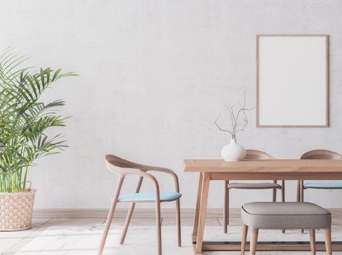 Wooden chairs and table on gray  background, rattan pot and trendy home accessories , Scandinavian dining room interior design with empty wooden frame template.