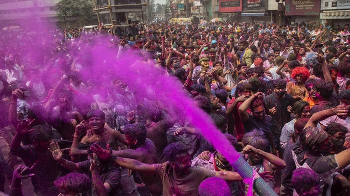 Indians dance during Holi festival celebrations in Gauhati, India, Monday, March 29, 2021. Hindus threw colored powder and sprayed water in massive Holi celebrations Monday despite many Indian states restricting gatherings to try to contain a coronavirus resurgence rippling across the country. (AP Photo/Anupam Nath)